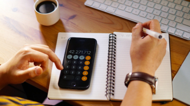 A closeup shot of an entrepreneur working from home and doing calculations