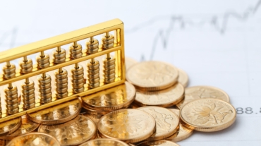 golden-abacus-with-chinese-rmb-gold-coins-as-background-min